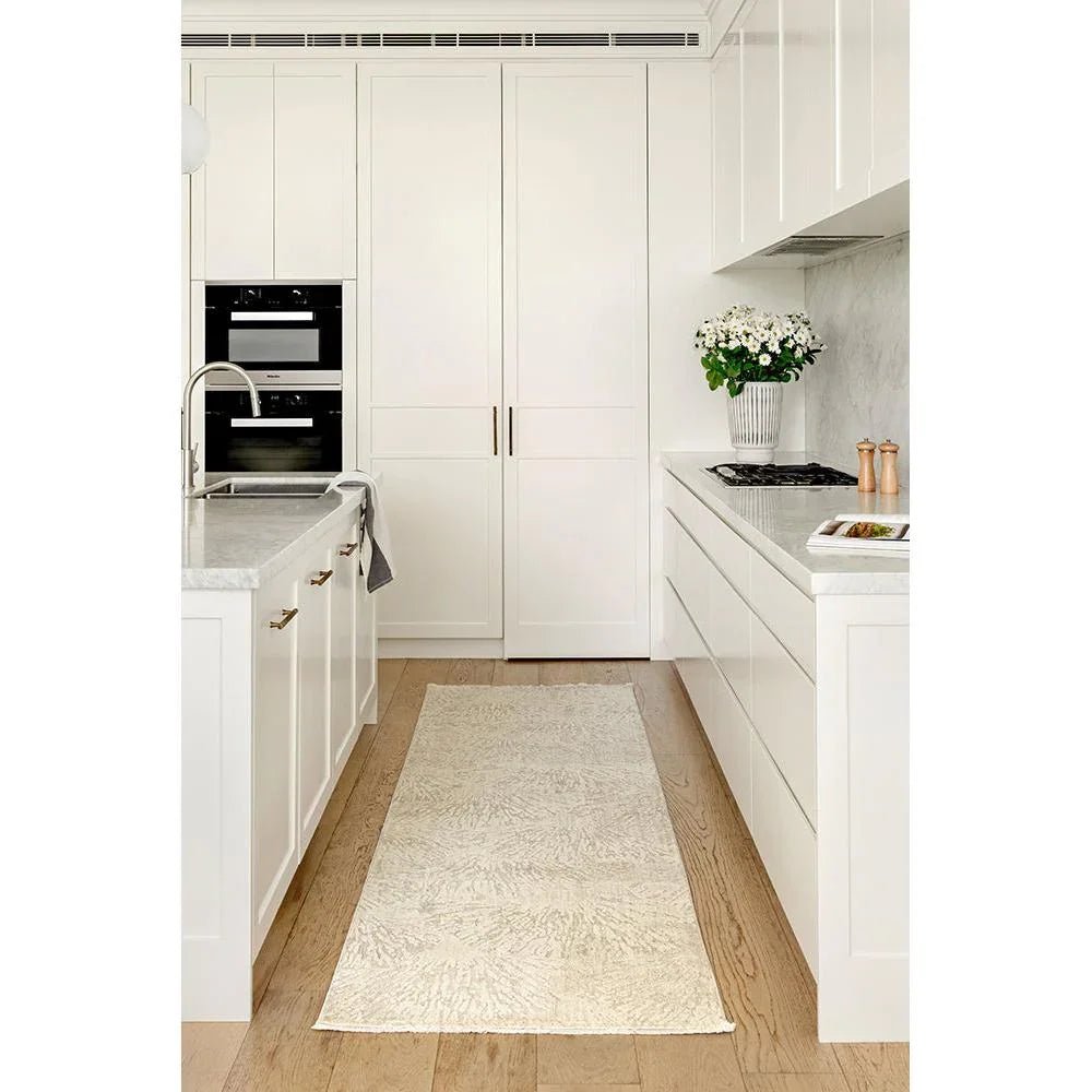 Emma Blomfield Plume Oat Rug featuring subtle plume pattern in ivory, cream and oat beige on warm beige floor, hand-tufted wool
