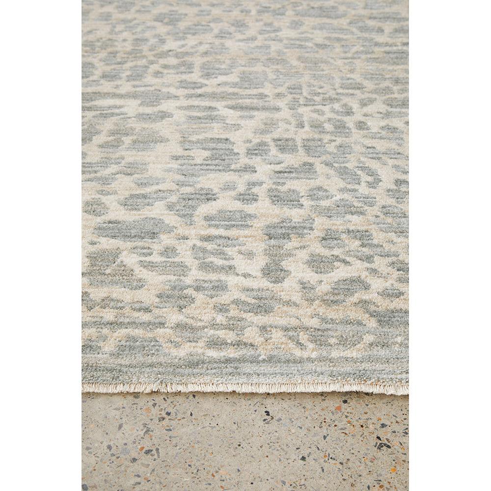 Emma Blomfield Rogue Mist Rug featuring abstract animal-print in blue-grey, beige and ivory on cream, hand-tufted wool