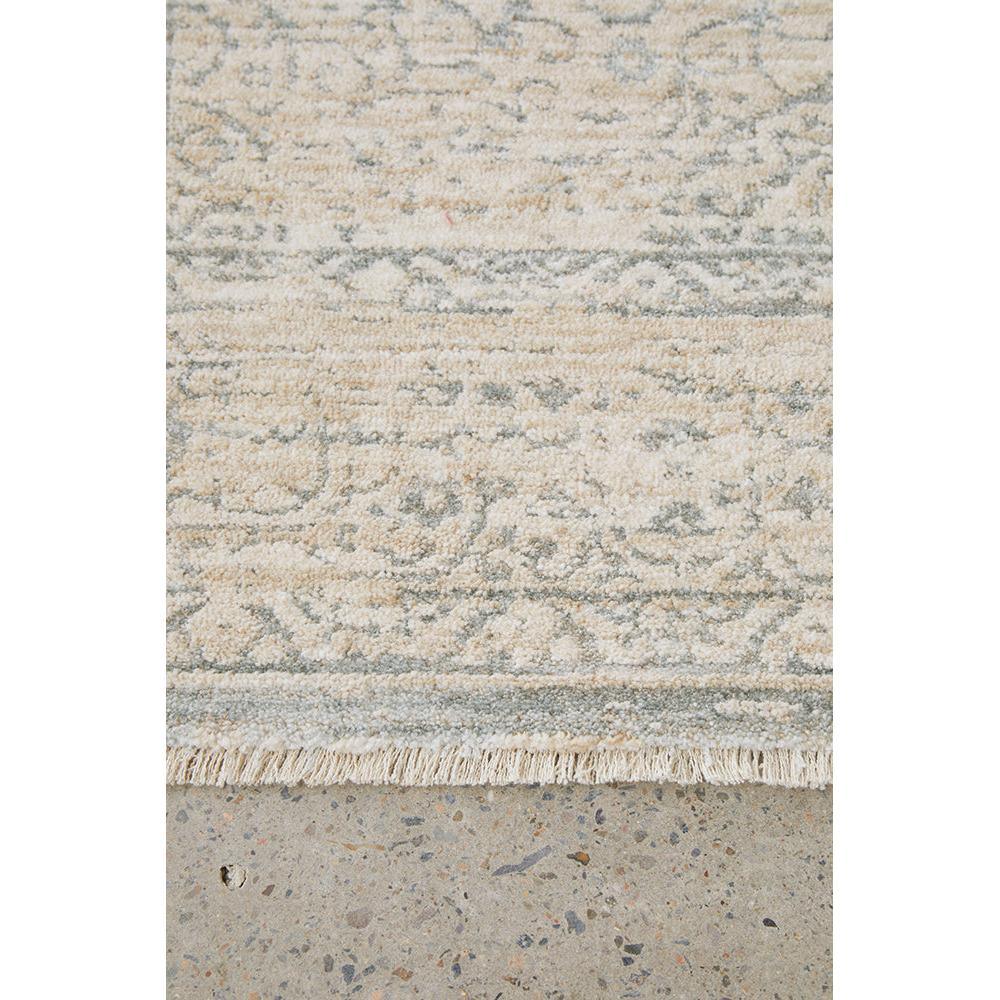 Emma Blomfield Veil Blue Rug featuring distressed floral pattern in cream and grey-blue on light background, woven wool