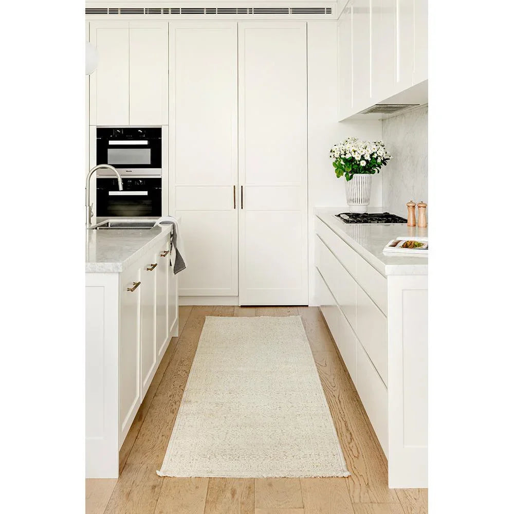 Emma Blomfield Veil Natural Rug featuring delicate textured weave in ivory and cream on pale oak floor
