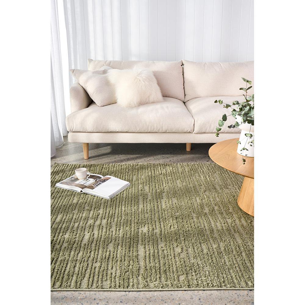 Marigold Suri Green Rug featuring textured linear stripes in olive and moss on light beige floor, machine-woven polyester