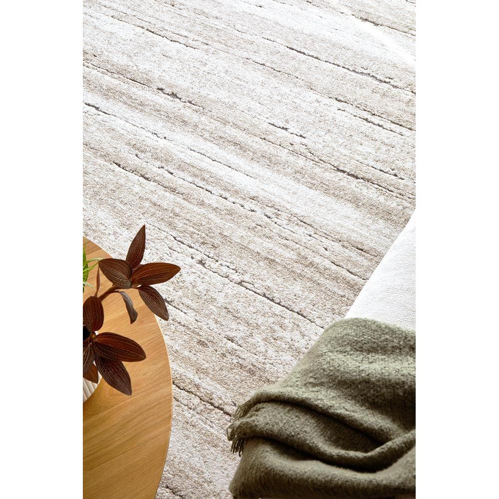 Close-up of a textured surface with a wooden object and green fabric.