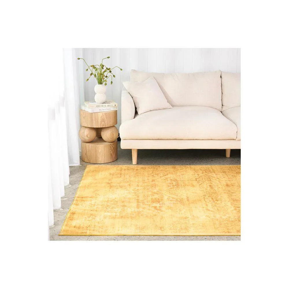 Gemstone Amber Rug featuring solid contemporary texture in amber yellow on pale grey floor, power-loomed polyester