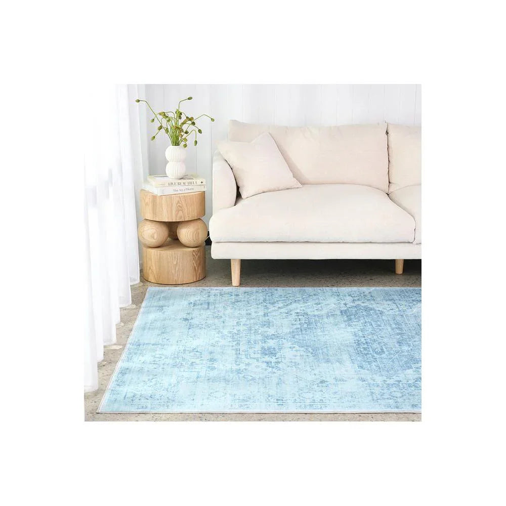 Gemstone Aquamarine Rug featuring distressed abstract pattern in aquamarine blue and white on beige background, hand-tufted wool