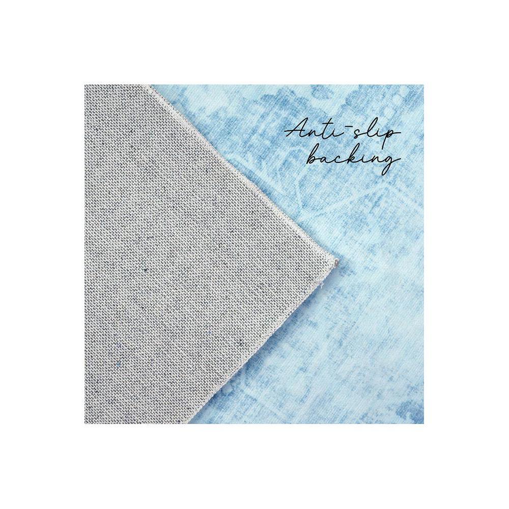 Gemstone Aquamarine Rug featuring marble wash pattern in aquamarine, light blue and white on pale blue background, anti-slip backing, machine-woven polyester