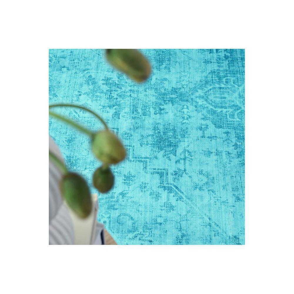 Gemstone Topaz Rug featuring distressed floral pattern in teal, turquoise and azure on cream background, hand-tufted wool