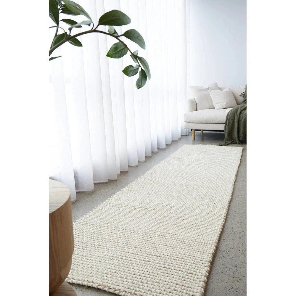 Harlow Cove Cream Rug featuring textured flat-weave in ivory, cream and beige on light grey floor, handwoven cotton