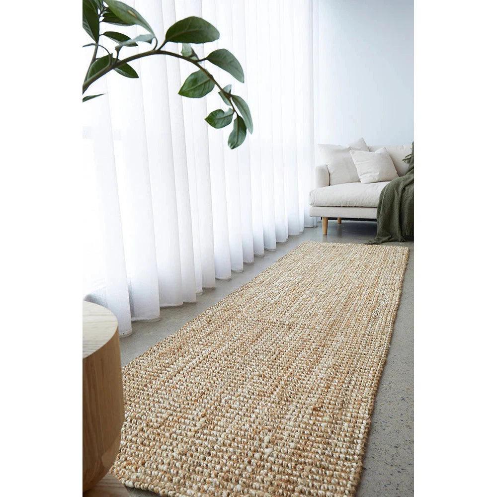 Harlow Hunter Natural Rug featuring textured woven fibres in beige, cream and ivory on a light grey floor, hand-woven jute