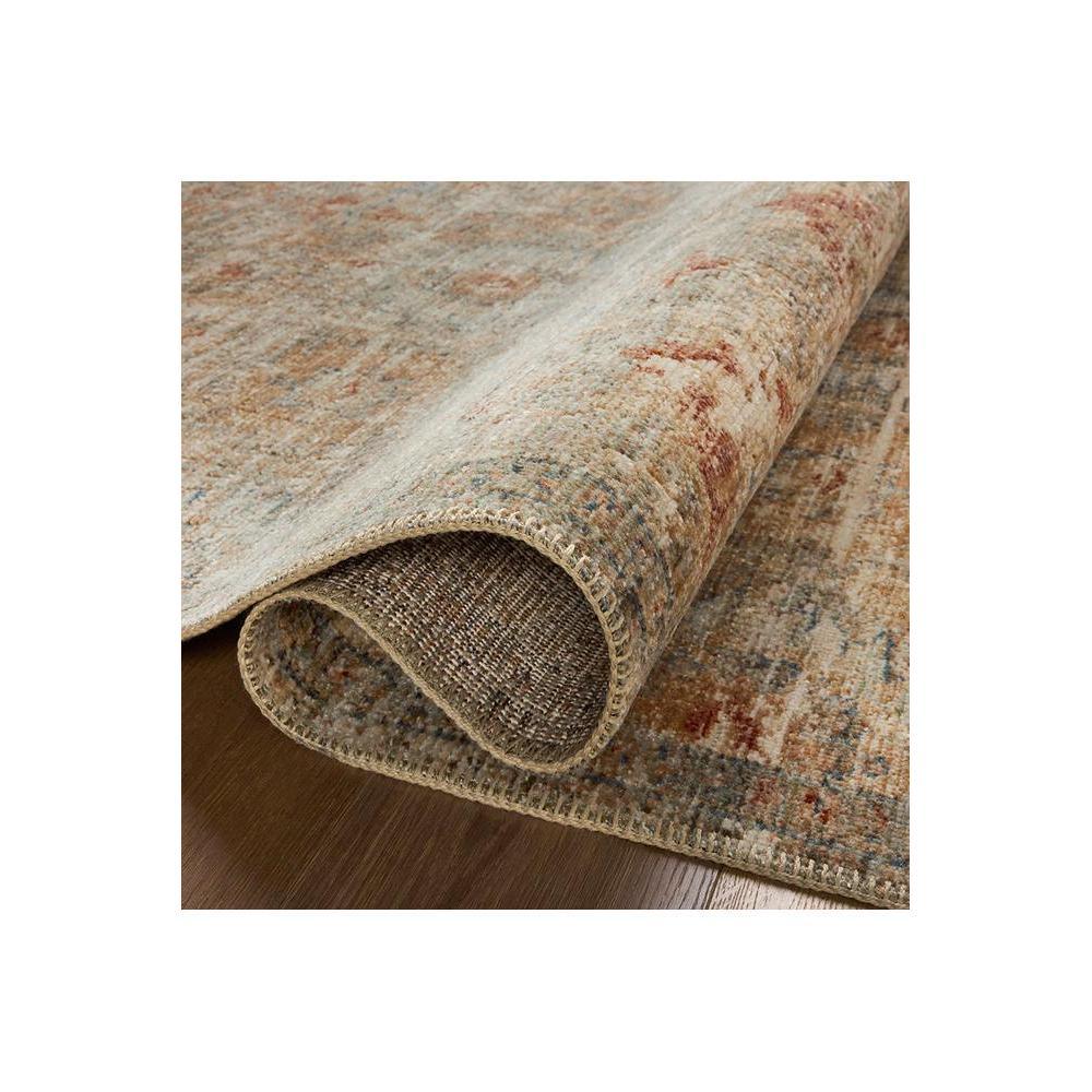 Heritage Grey Rug featuring distressed vintage pattern in cream, beige, taupe, rust and blue-grey on warm brown wood background, machine-woven wool blend