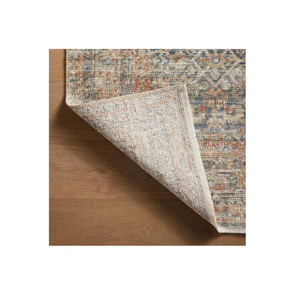 Heritage Blue Rug featuring distressed medallion pattern in navy, blue-grey, cream and terracotta on cream background, hand-tufted wool