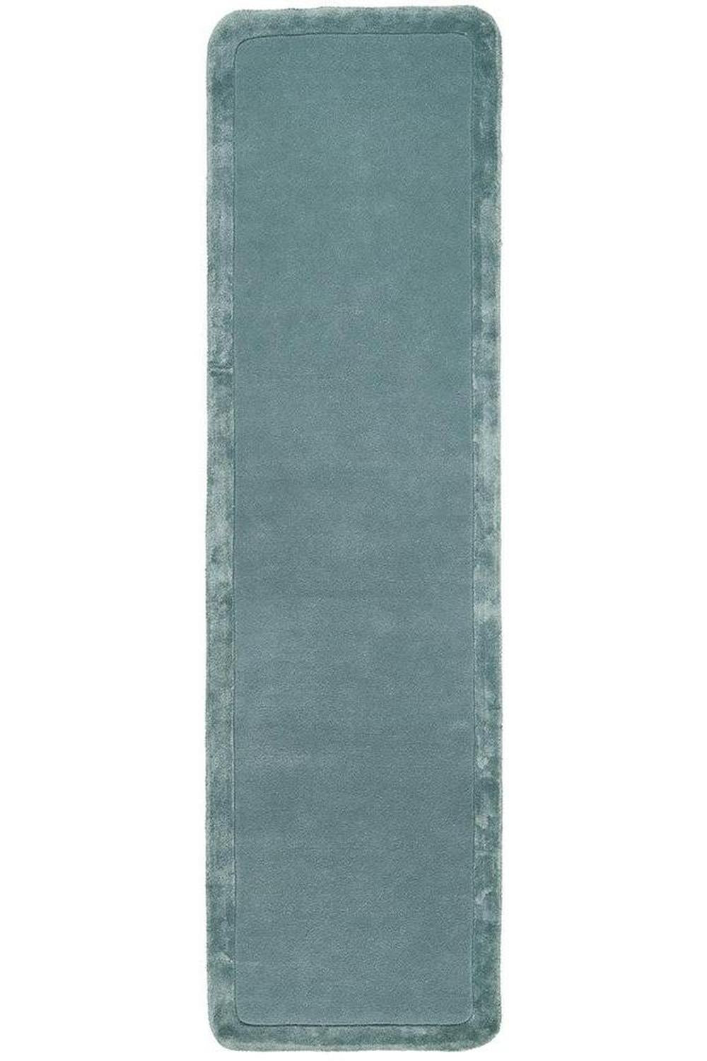 Long rectangular blue bath mat on a white background
