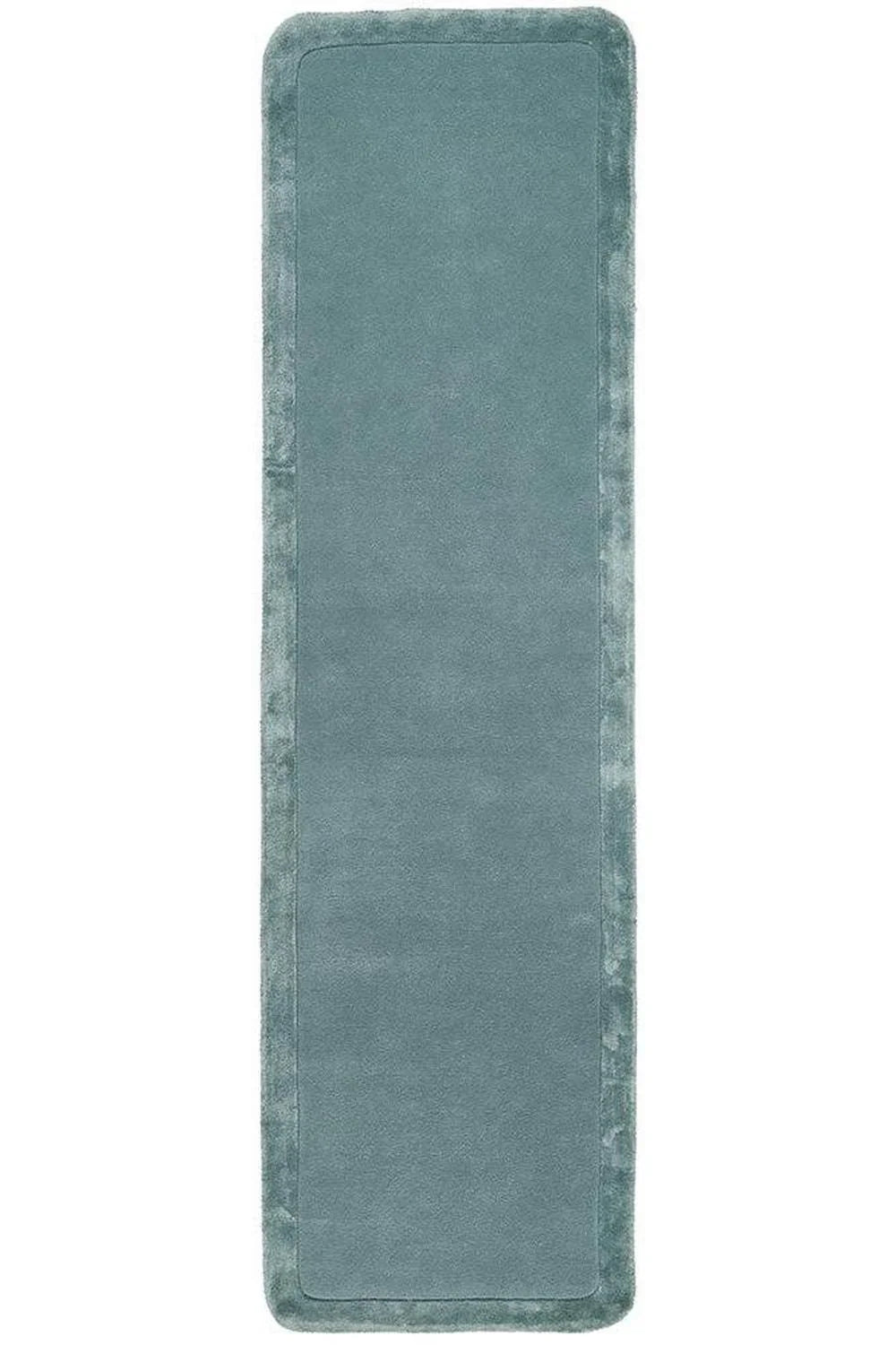 Long rectangular blue bath mat on a white background