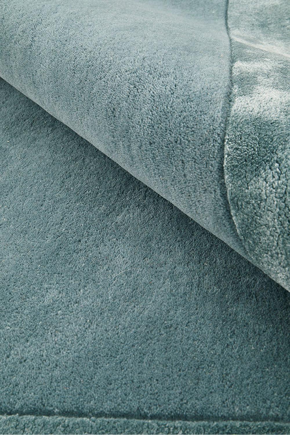 Hugo Rug featuring solid plush texture in teal blue, steel blue and navy on teal background, hand-tufted wool
