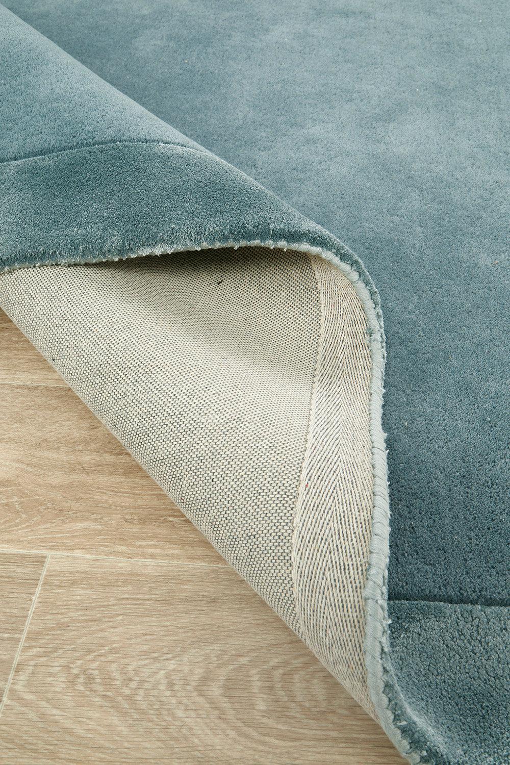 Hugo Blue Rug featuring teal blue and dusty blue velvet pile on cream backing, hand-tufted wool