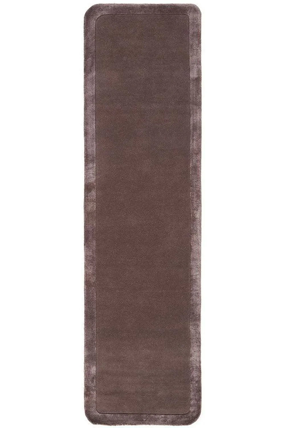 Hugo Grape Rug featuring solid design in grape brown with darker edging on white background, machine-made polyester