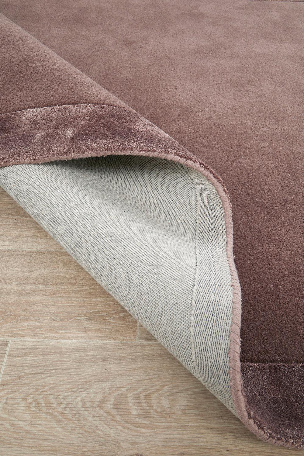 Hugo Rug featuring solid design in grape purple on cream-beige background, hand-tufted wool