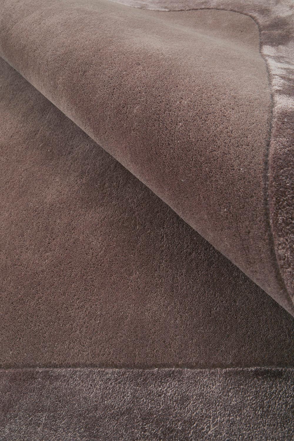 Hugo Rug featuring solid textured weave in brown, taupe and cocoa on warm brown background, machine-made textile