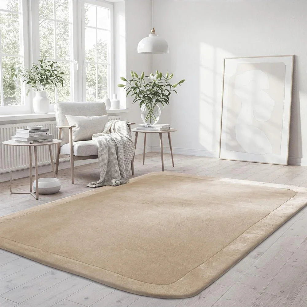 Beige rug in a modern living room with white walls and furniture.