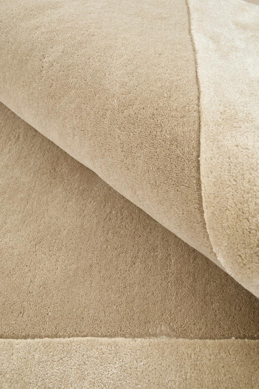 Hugo Husk Rug featuring solid textured boucle in warm beige, cream and taupe on cream background, hand-tufted wool