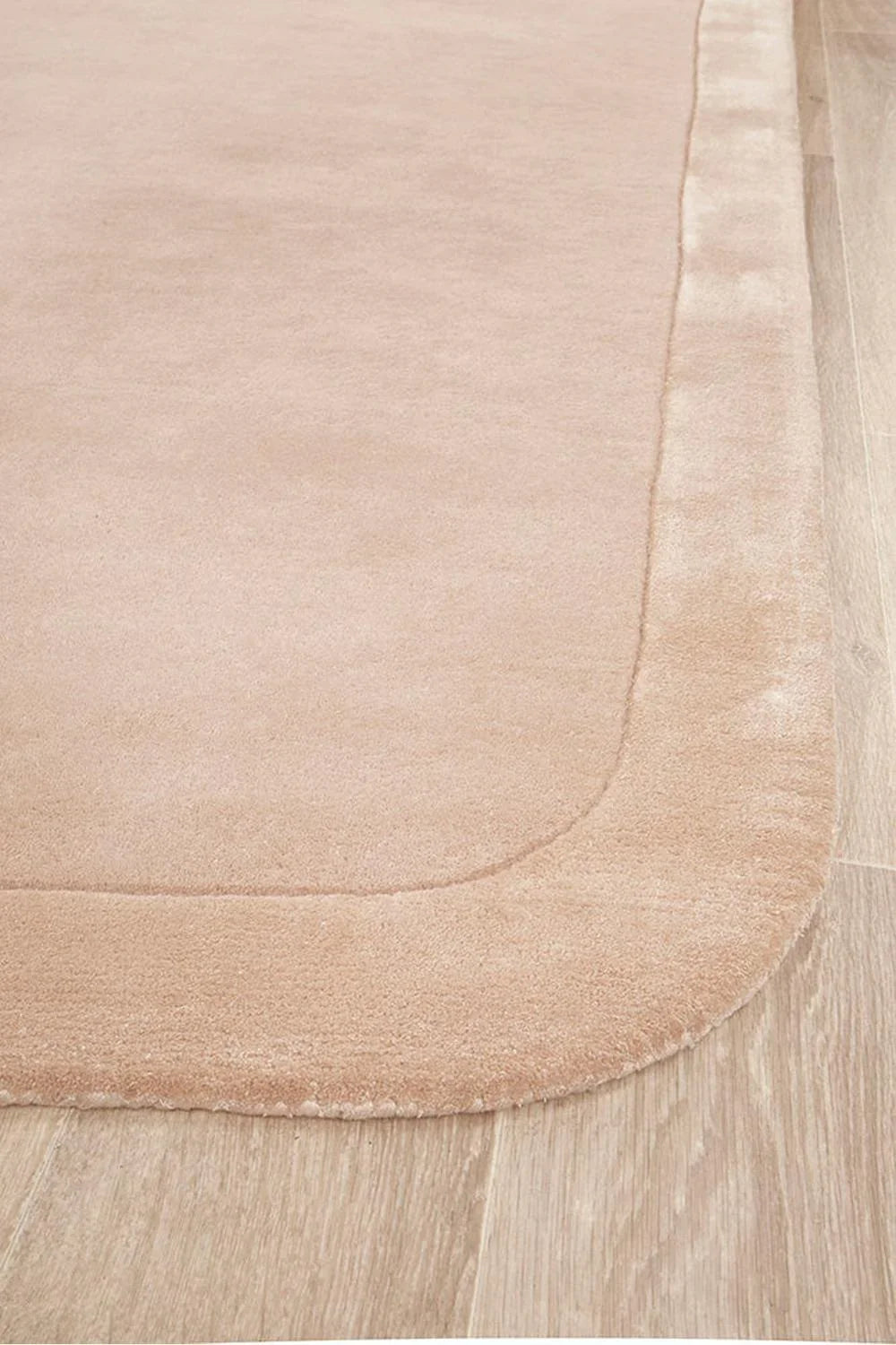 Hugo Nude Runner Rug featuring solid plush texture in nude, blush beige and cream on light wood floor, hand-tufted wool