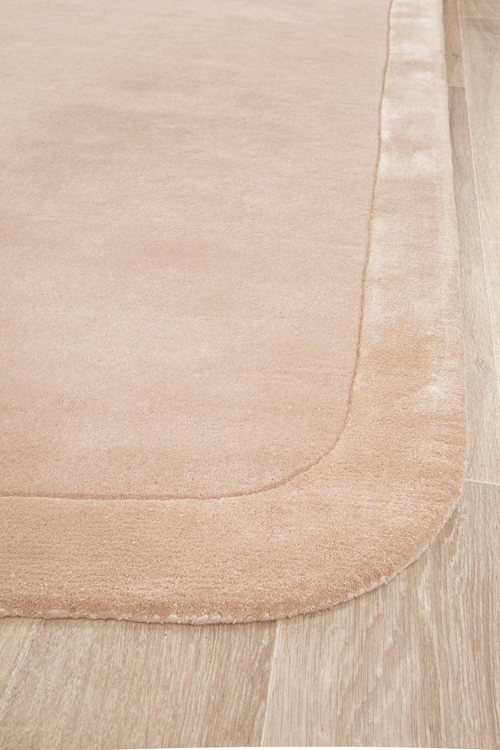 Hugo Nude Rug featuring solid minimalist design in blush pink, beige and cream on warm beige background, Rug Culture