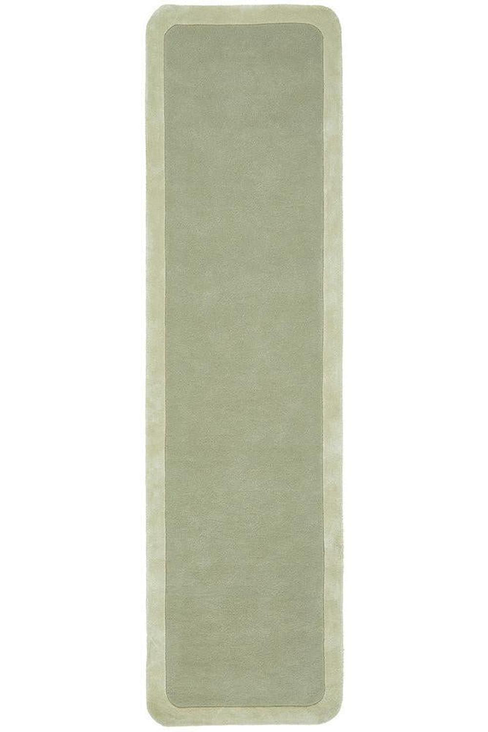 Long rectangular green rug on a white background