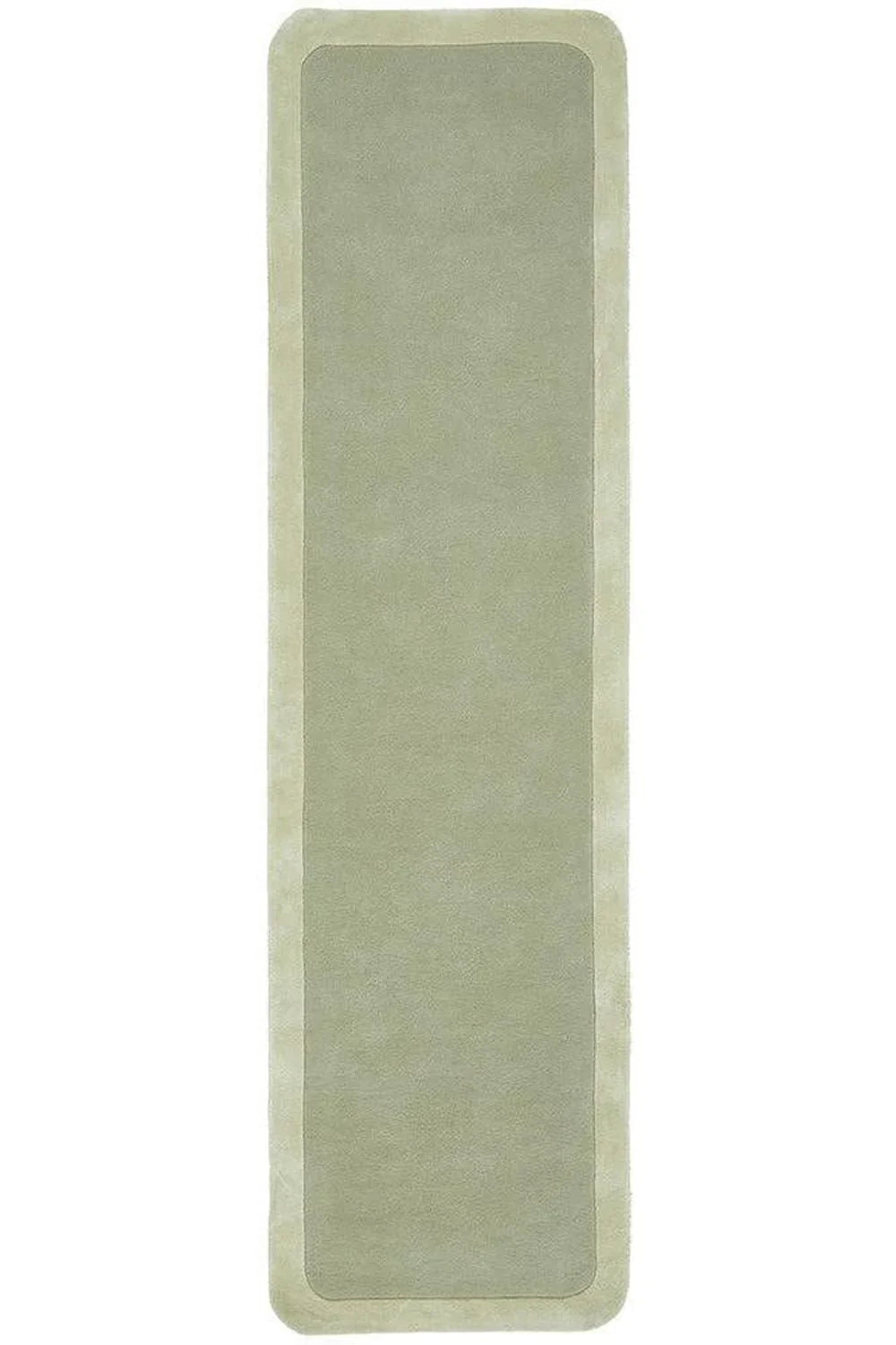 Hugo Sage Rug featuring solid minimalist design in sage green with pale cream border on light taupe background, hand-tufted wool