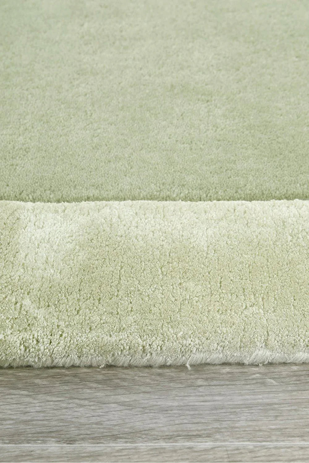 Hugo Sage Runner Rug featuring solid shag in sage green on light grey floor, machine-made polyester