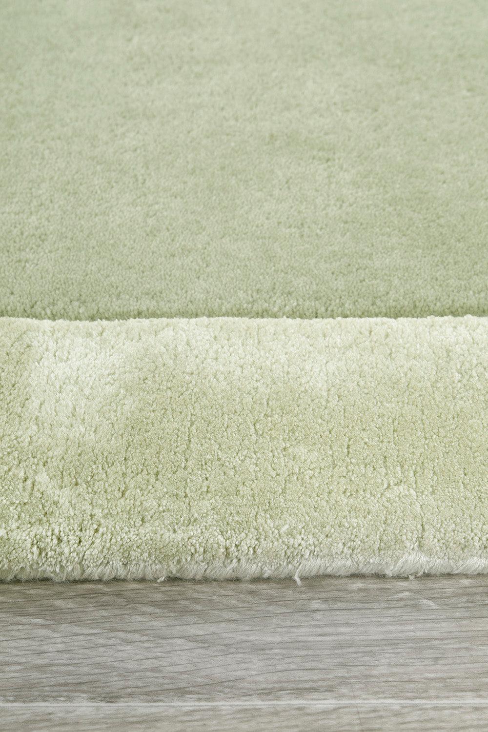 Hugo Sage Rug featuring solid shag design in sage green and cream on light-wood background, machine-made polyester
