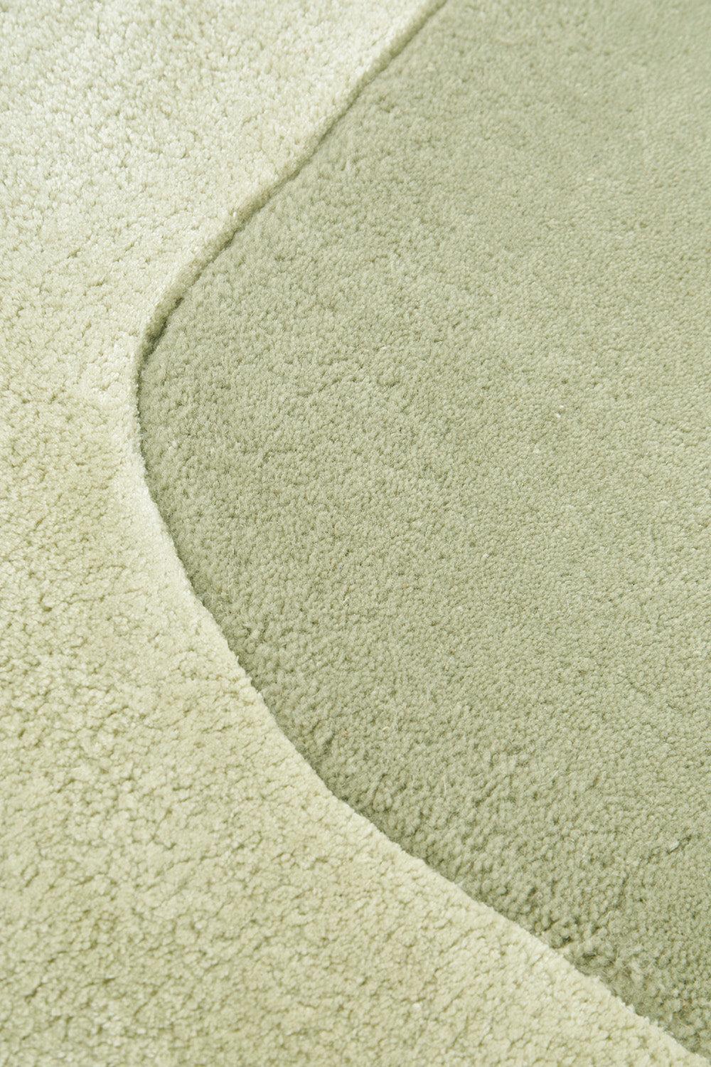Hugo Sage Rug featuring textured curved pattern in sage, olive and light sage on pale sage background, machine-made polypropylene
