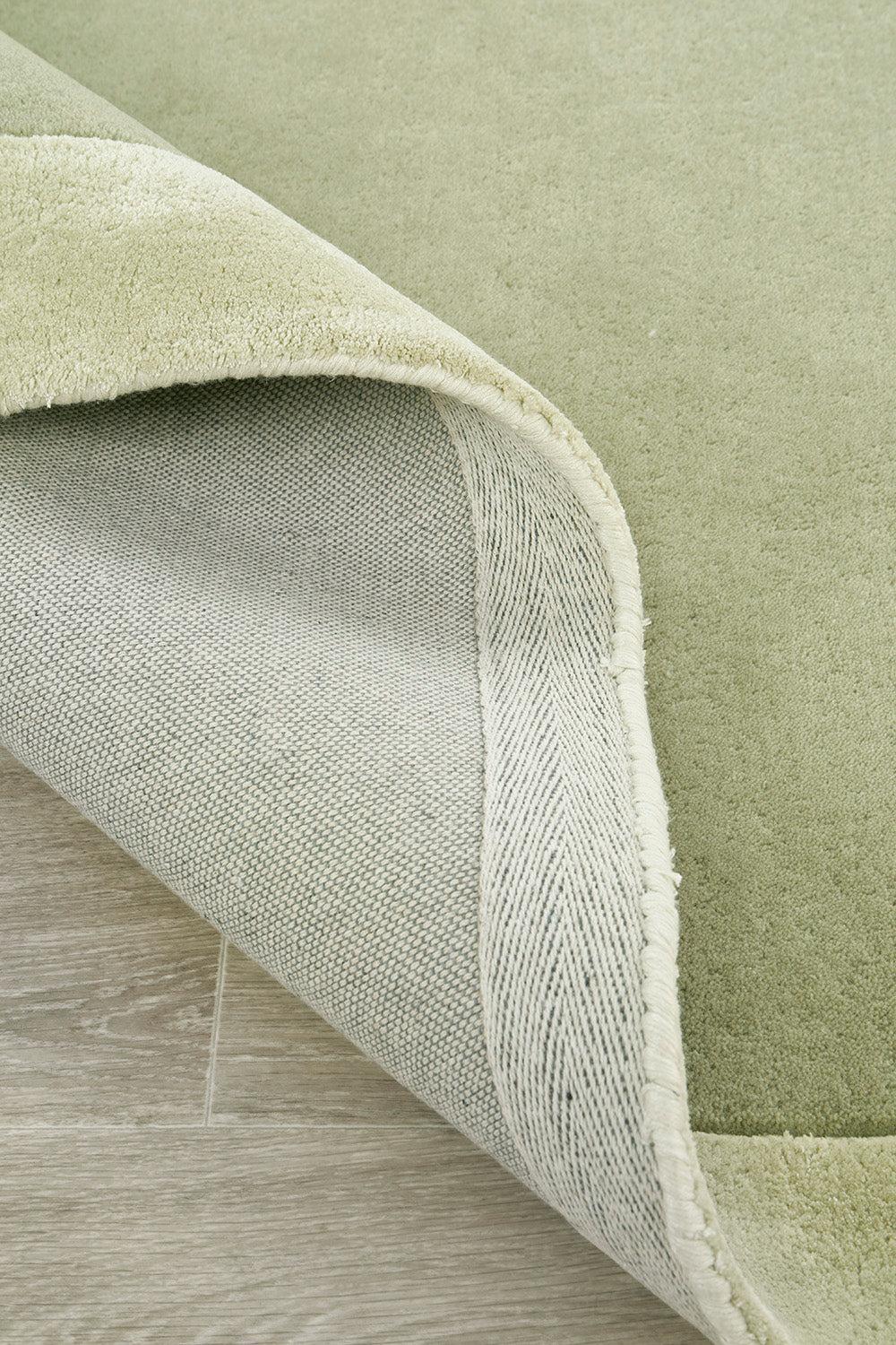 Hugo Sage Rug featuring solid sage-green minimalist design in sage and olive on light beige backing, hand-tufted wool