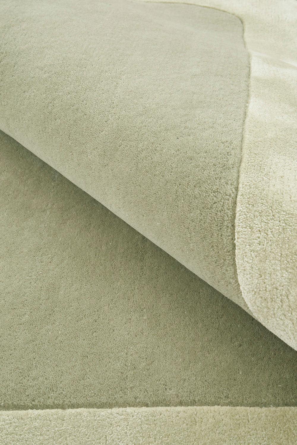 Hugo Sage Rug featuring solid boucle texture in sage-green and cream on soft cream background, hand-tufted wool
