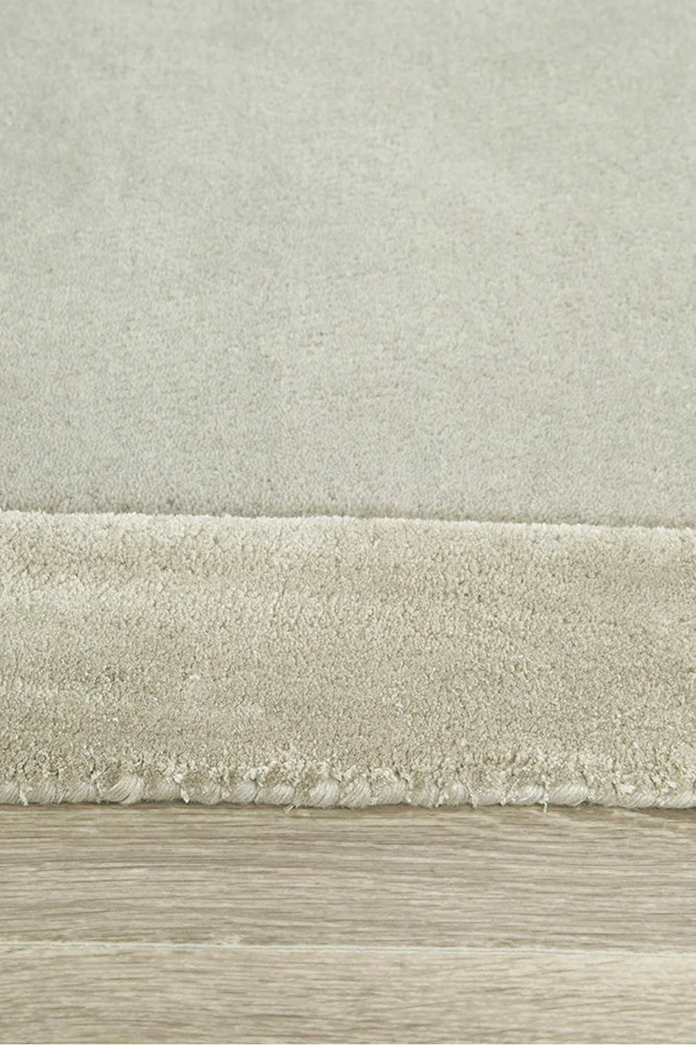 Hugo Silver Runner Rug featuring solid shag pattern in cream, ivory and taupe on light oak floor, machine-made wool