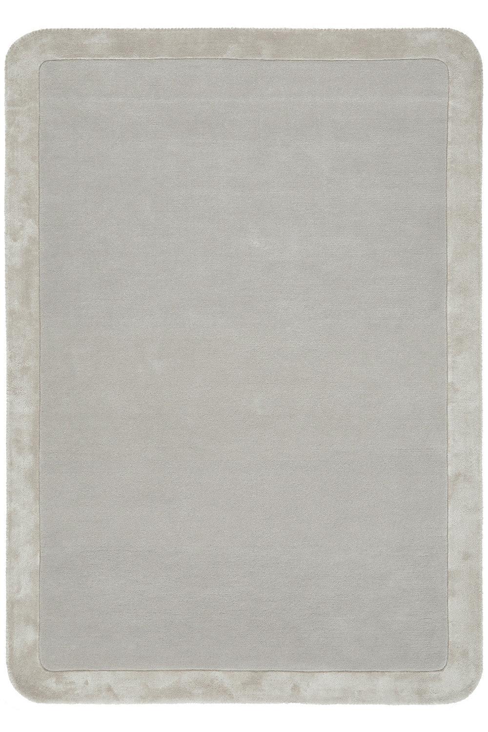 Rectangular rug with a textured border on a plain background