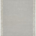 Rectangular rug with a textured border on a plain background