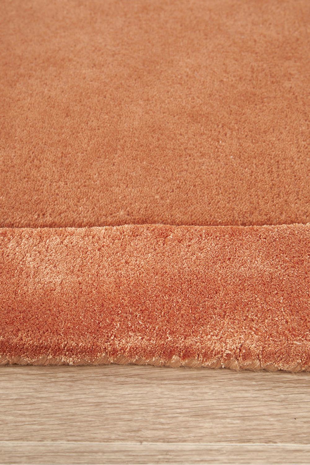 Hugo Spice Runner Rug featuring solid terracotta orange pile in spice tones on light wood floor, machine-made wool blend