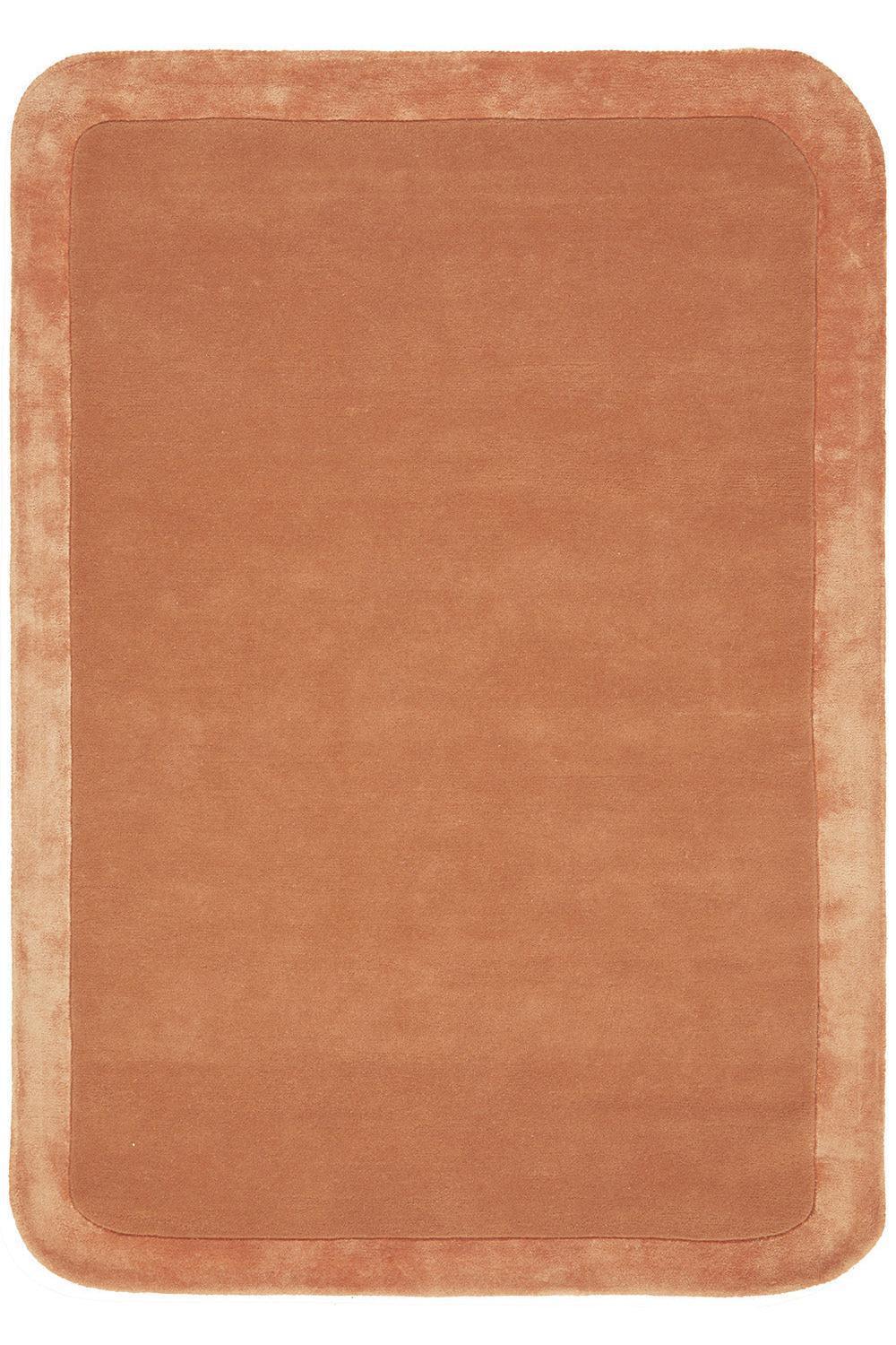 Rectangular brown bath mat with a textured surface on a white background