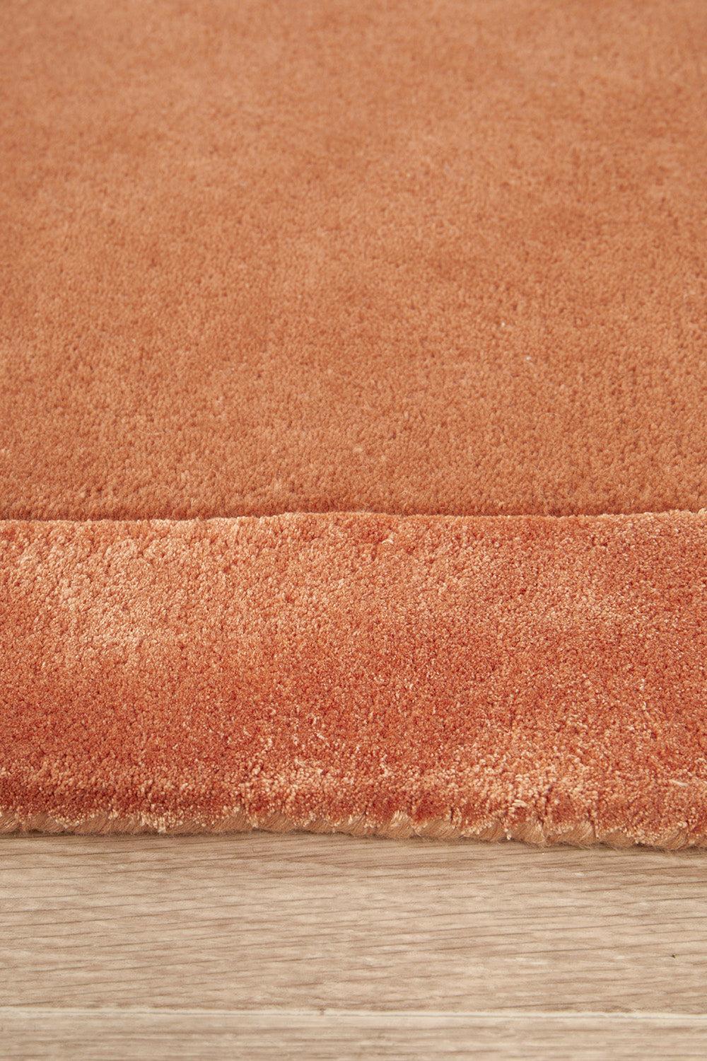 Hugo Spice Rug featuring solid texture in warm spice, terracotta and copper on beige background, hand-tufted wool