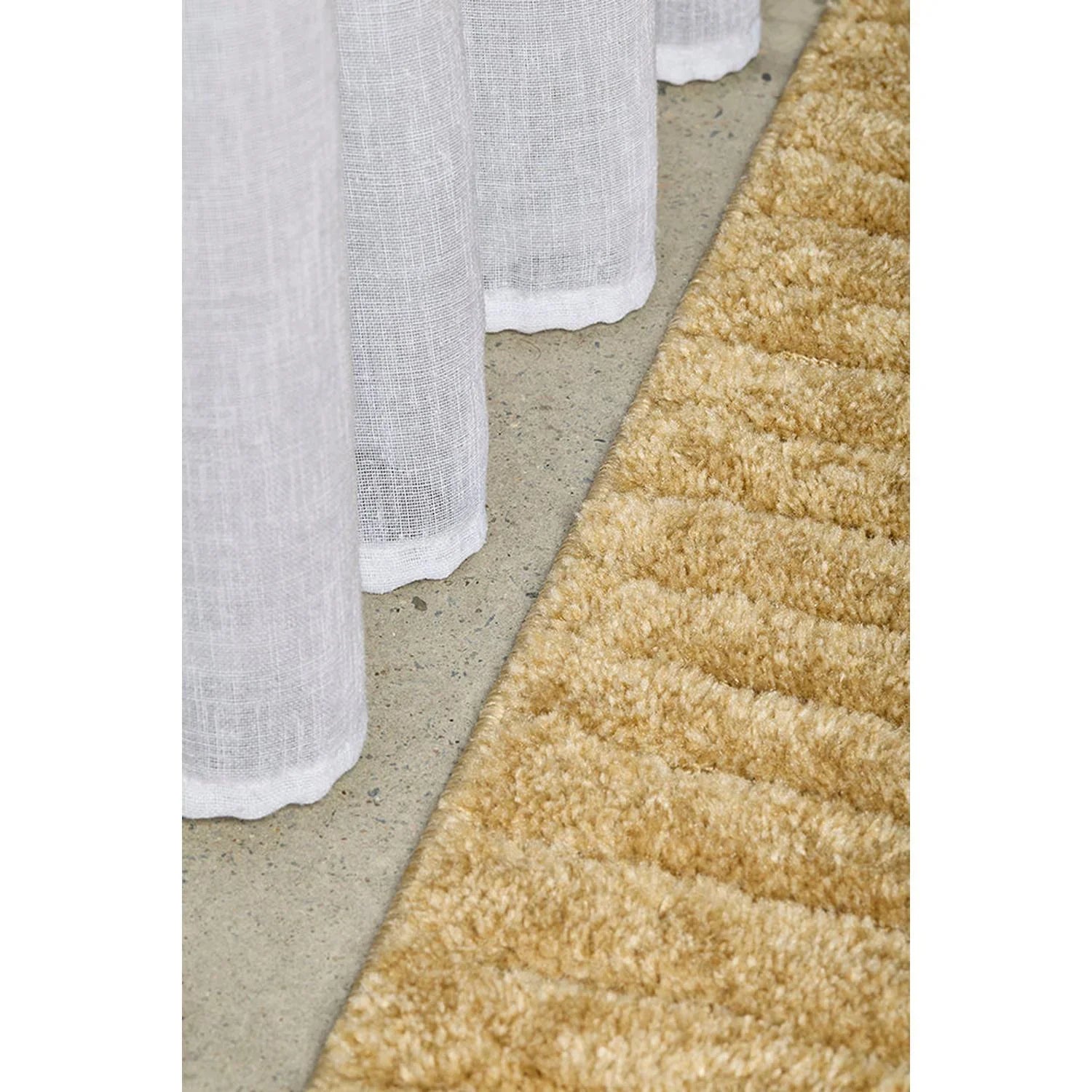 Haven Aliya Gold Rug featuring plush shag in warm gold on concrete grey with beige accents, hand-tufted wool