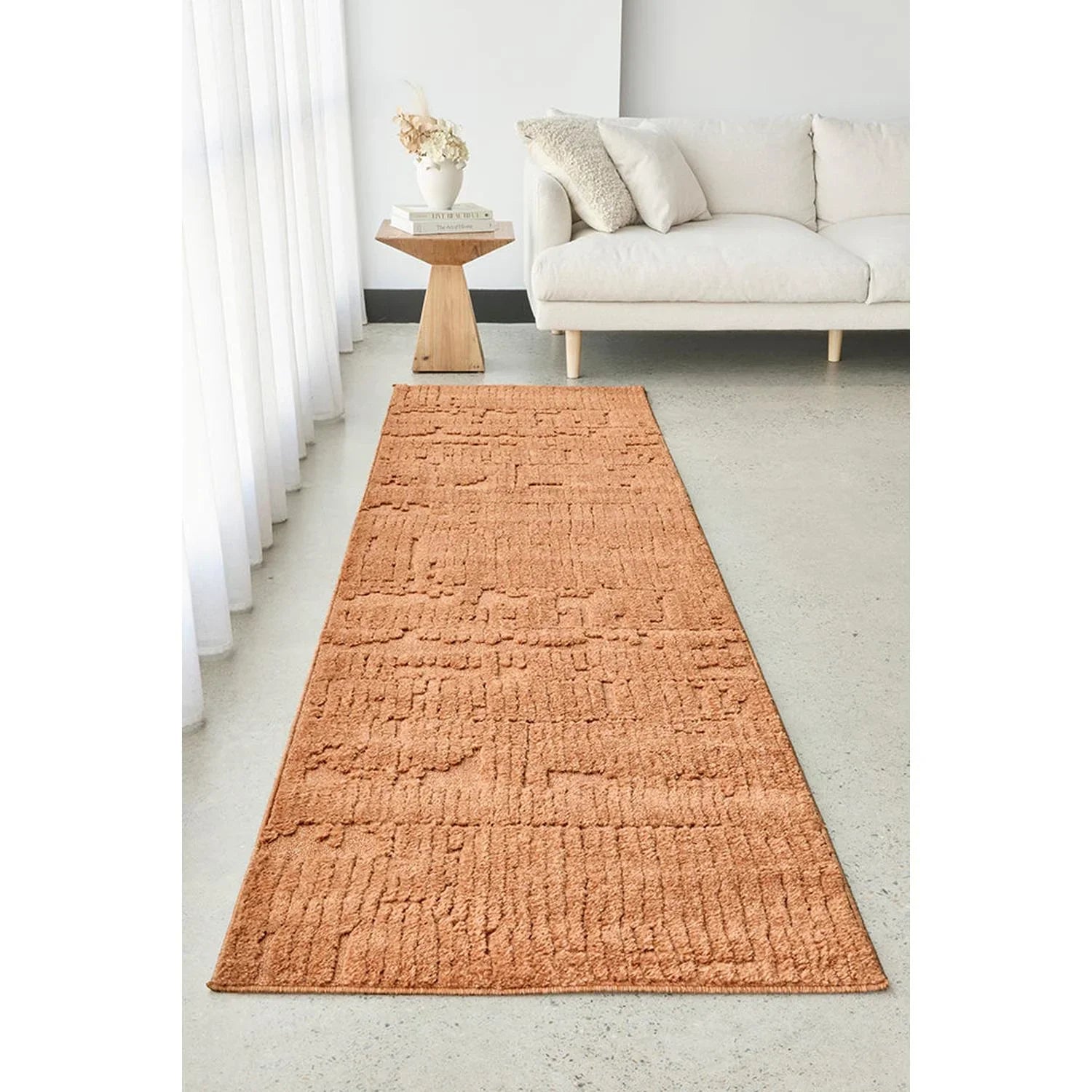 Haven Aliya Rust Rug featuring a textured linear pattern in rust/terracotta on light grey floor, hand-tufted wool