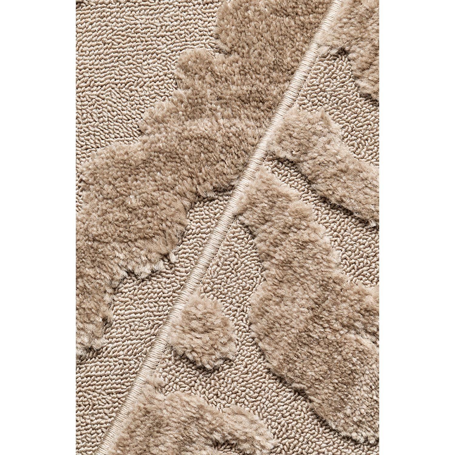 Close-up of a textured beige carpet with leaf pattern