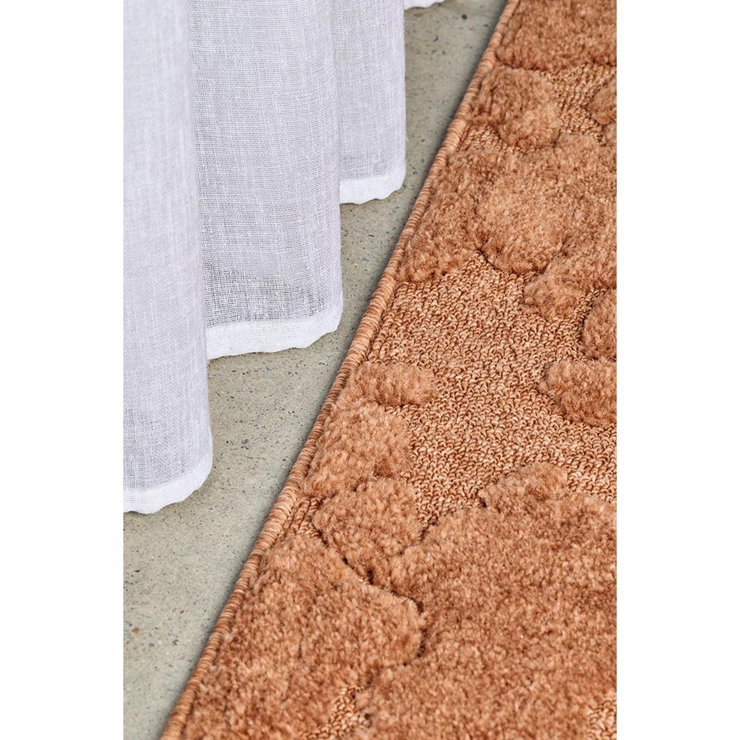 Haven Nyla Rust Rug featuring tufted circular pattern in rust, copper and cream on warm beige background, hand-tufted wool