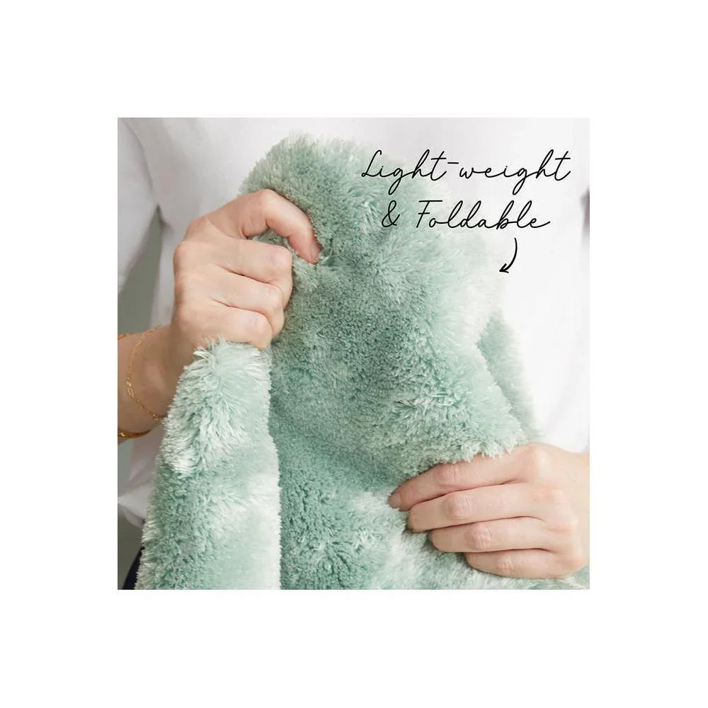 Jelly Bean Mint Green Rug featuring fluffy plush texture in mint green on white, lightweight and foldable, hand-tufted microfiber.