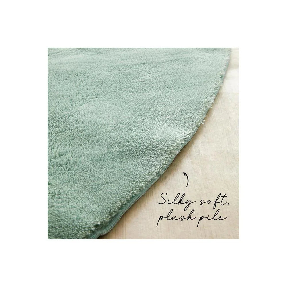 Jelly Bean Mint Green Rug featuring solid plush pile in mint green on light wood background, hand-tufted wool