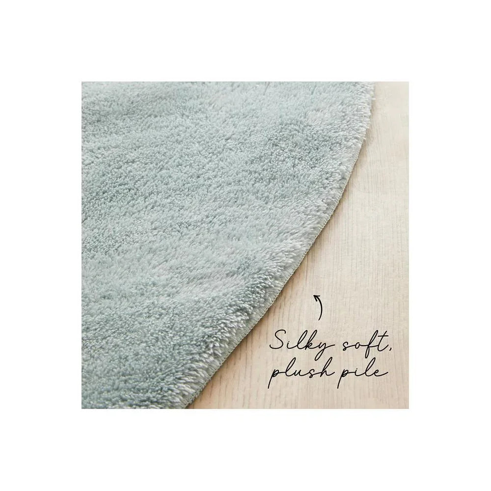 Jelly Bean Powder Blue Rug featuring plush shag pile in powder blue on light wood background, hand-tufted polyester