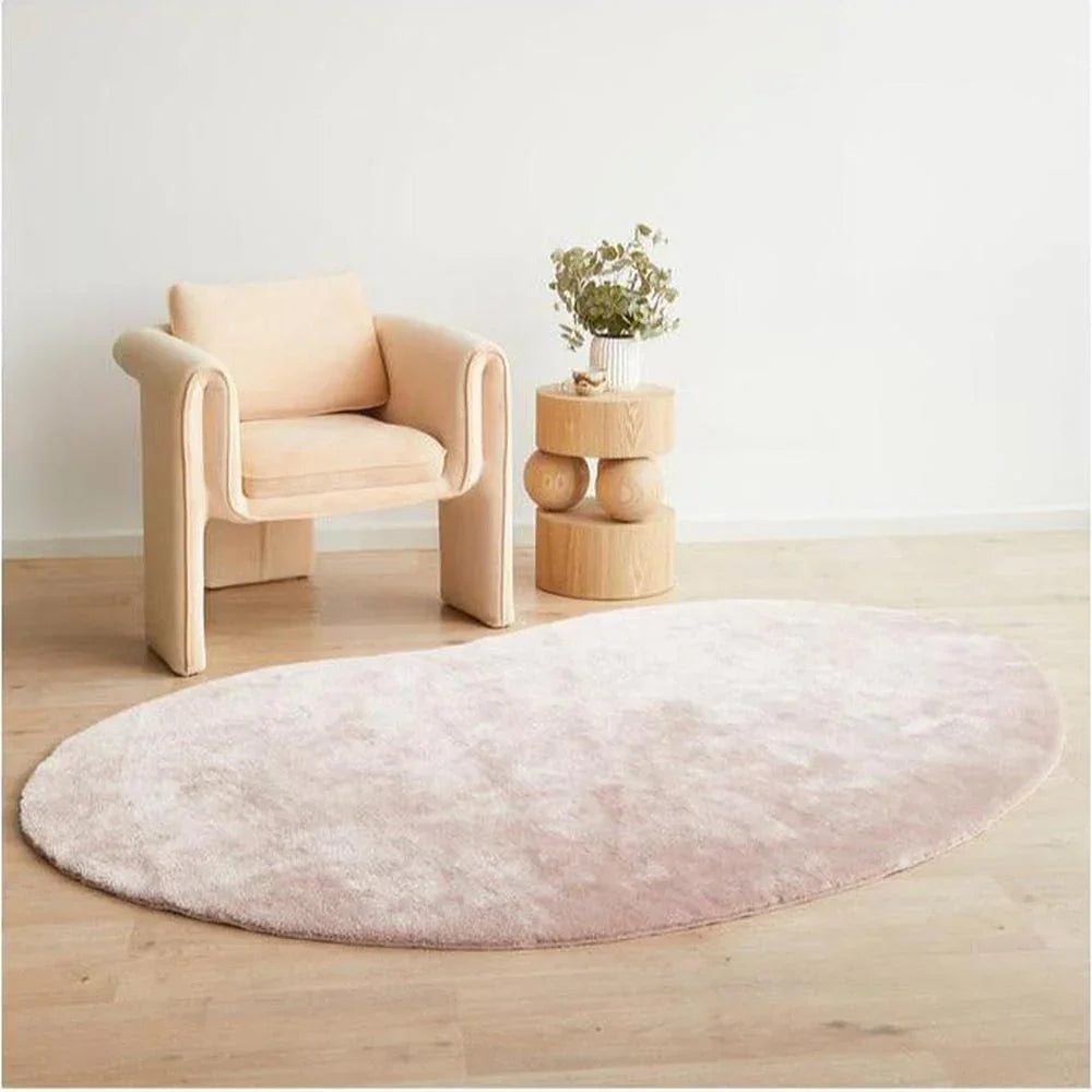 Jelly Bean Rose Rug featuring soft circular tufted pattern in blush pink, cream and ivory on pale wood floor, hand-tufted wool
