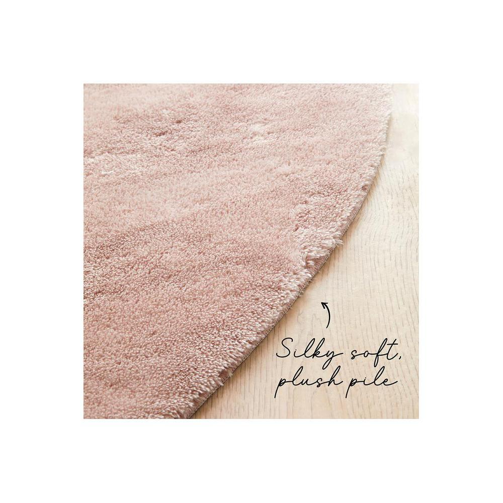 Jelly Bean Rose Rug featuring round shag pile in blush pink on light wood floor, round rug, synthetic fibre
