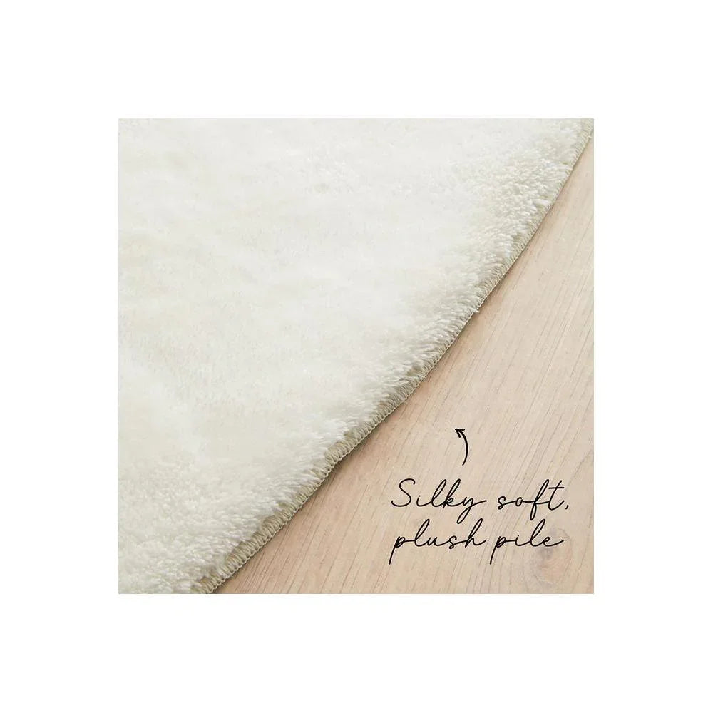 Jelly Bean Snow White Rug featuring silky soft plush pile in ivory, cream on pale wood background, hand-tufted wool