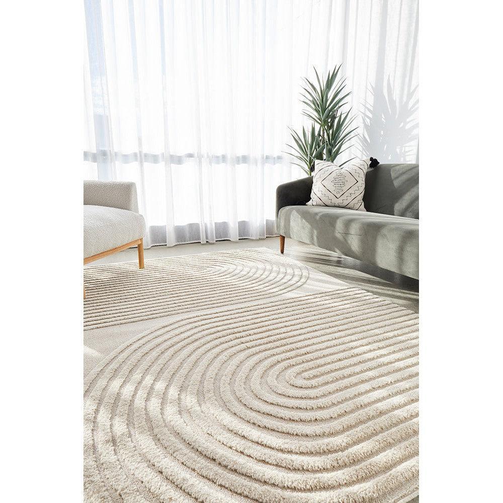 Lotus Abbey Beige Rug featuring concentric ripple pattern in cream, beige and taupe on light beige, machine-woven polyester