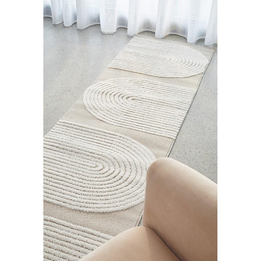 Lotus Abbey Mixed Runner Rug featuring circular spiral pattern in ivory, cream and beige on warm beige background